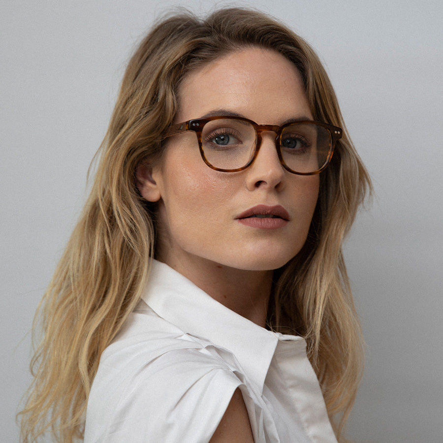 Woman wearing caramel rectangle small glasses 
