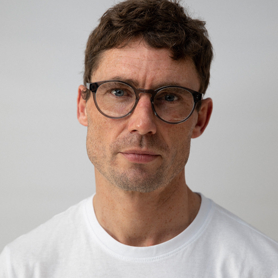 Man wearing clear grey frame glasses