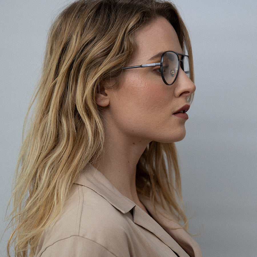 Woman wearing Aviator glasses with silver frame looking sideways