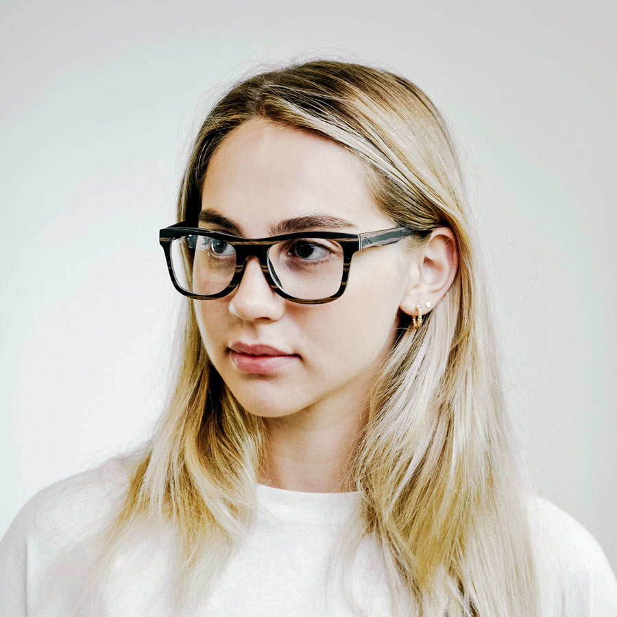 girl wearing square wooden glasses 