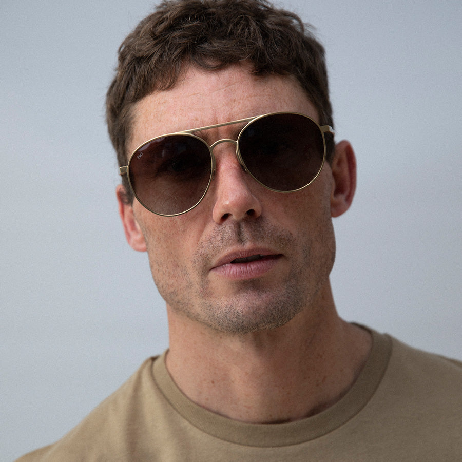Man wearing large aviator sunglasses with polarised lenses