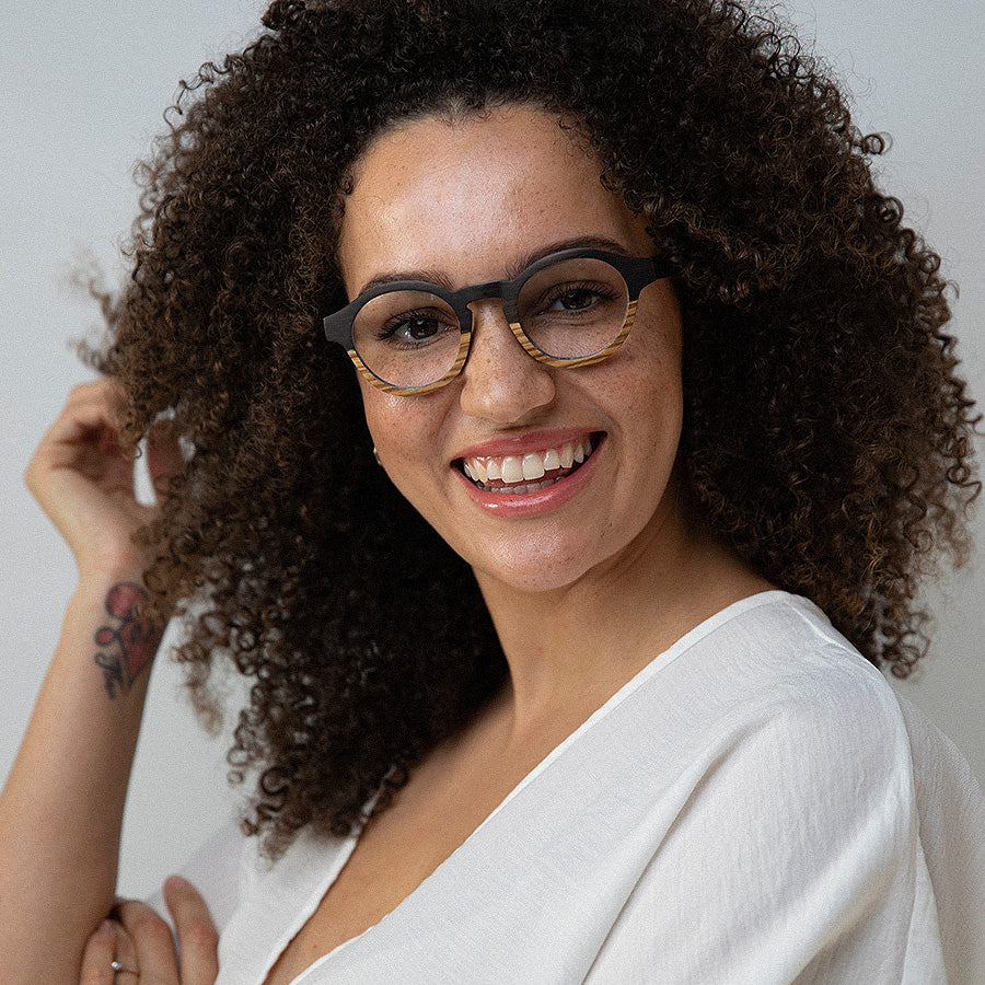 Black woman wearing round wooden glasses for optical lenses 
