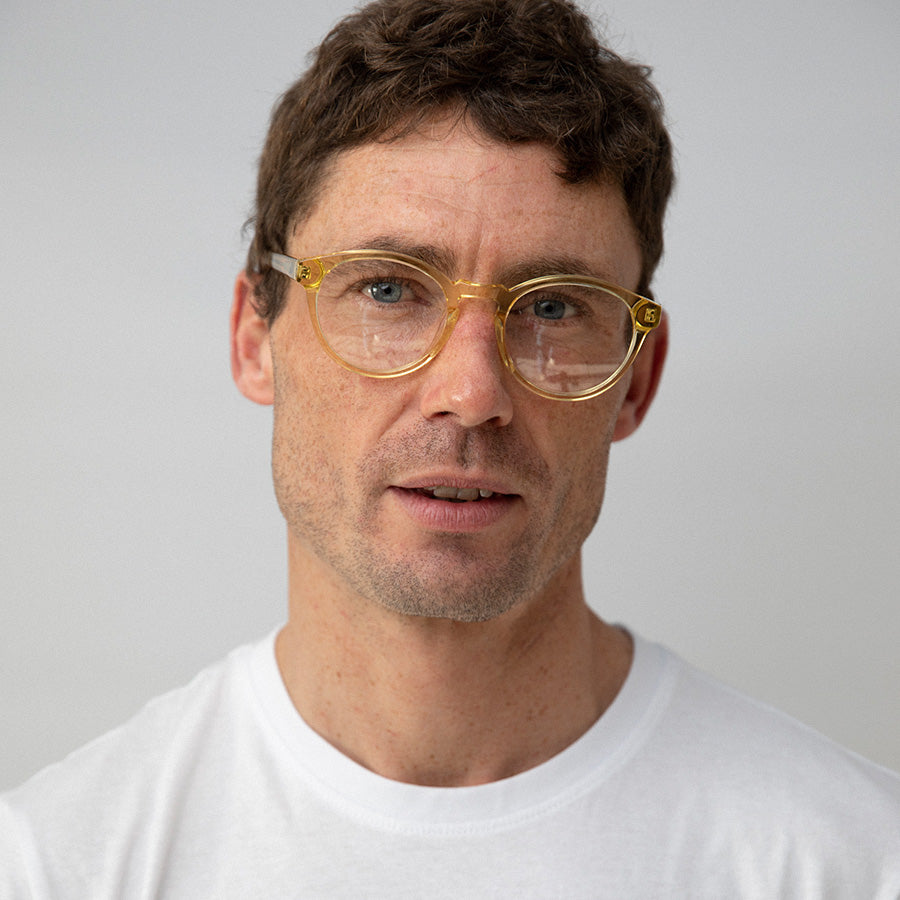 White man wearing yellow glasses