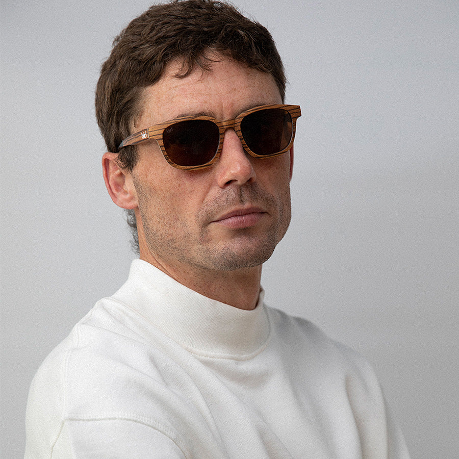 Man wearing  Eco conscious wooden sunglasses with light coloured wood