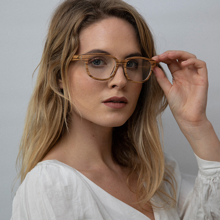 Woman wearing eco friendly glasses frame made with light wood