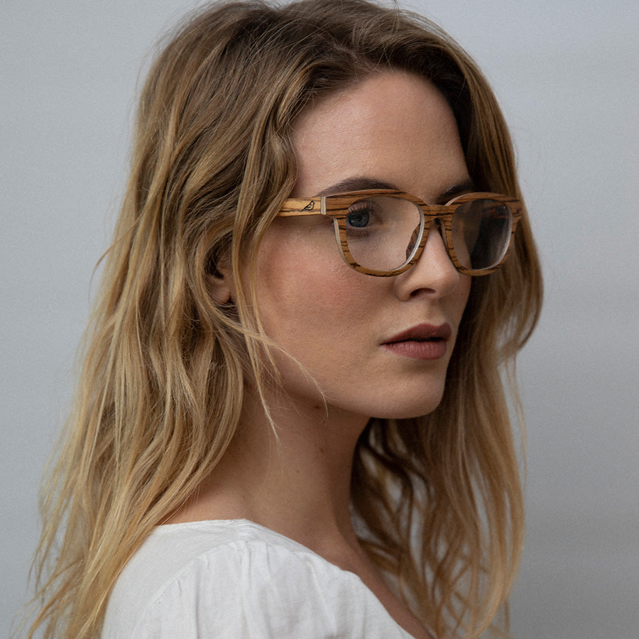 Woman wearing eco friendly glasses frame made with light wood facing sideways