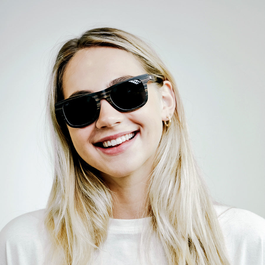 Girl wearing Wooden sunglasses with grey polarised lenses